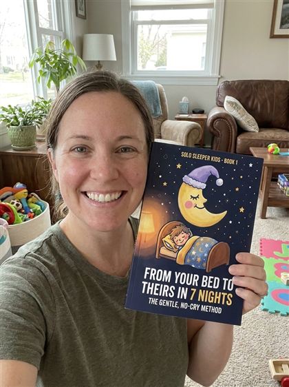 Mom holding Book 1 in her living room