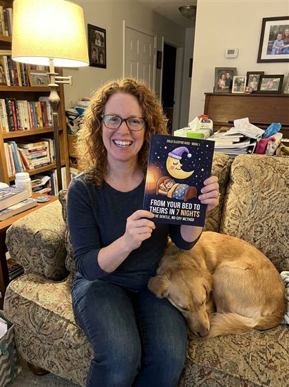 Mom on the sofa holding Book 1